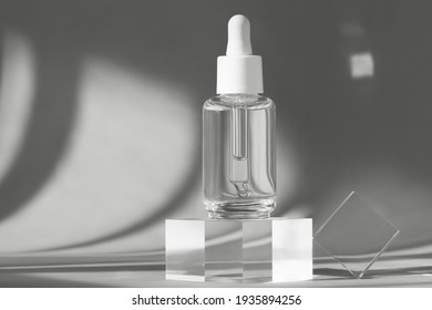 Serum bottle with peptides and retinol product packaging on modern acrylic transparent blocks with shadows from sun, cosmetic mockup on geometric stand, pedestal, cosmetics podium, skincare concept