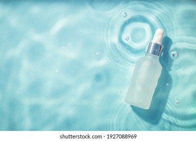 Serum bottle under water. Cosmetic product. Moisturizing, reparing and skincare.