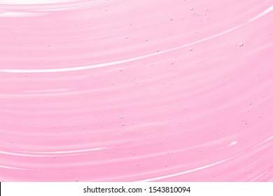 Serum, Liquid Gel Texture. Transparent Cosmetic Cream Background. Clear Pink Skincare Product Smudge