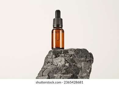 Serum, massage oil in glass dropper bottle on basalt. - Shutterstock ID 2365428681