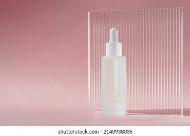 Serum Oil With Collagen And Peptide In White Transparent Bottle With Dropper On Pink Decor Backdrop With Acrylic Ribbed Sheet. Skincare Treatment Skincare Mockup Packaging Liquid Cosmetic Product.