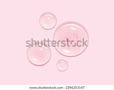 Serum oil sample swatch round shape texture isolated on pastel pink background. cosmetic Hyaluronic acid retinol collagen science lab product 