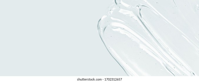 Serum texture, clear liquid gel with bubbles. Cosmetic skin care product sample. Hand sanitizer, alcohol gel background