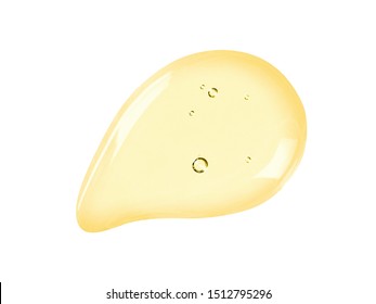 Serum texture. Face oil, liquid gel drop isolated on white background. Yellow colored cosmetic skincare product with bubbles swatch