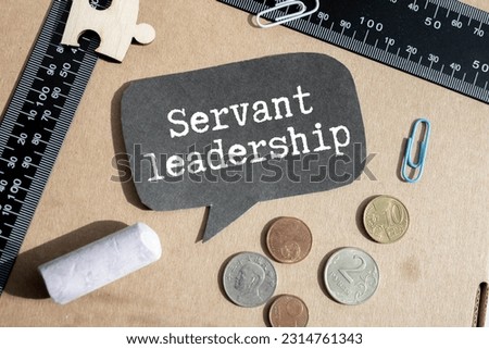 Servant Leadership write on paperwork isolated on Wooden Table