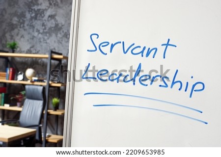 Servant leadership written on the whiteboard in the office.