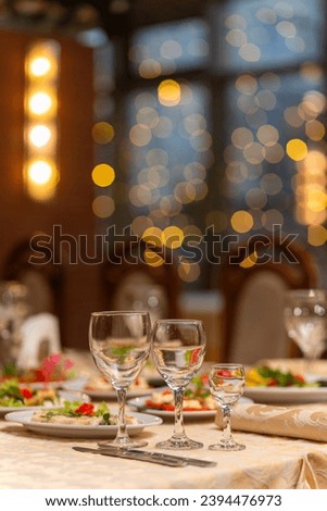 Served festive table with snacks, glasses, glasses, cutlery and napkins for a banquet on the occasion of a wedding or birthday or Christmas or other bright event in the restaurant