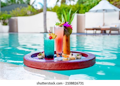served floating tray in swimming pool with drinks and snacks on tropical island resort in Maldives, cocktails and canapes for romantic date or honeymoon in luxury hotel, travel concept - Shutterstock ID 2108826731