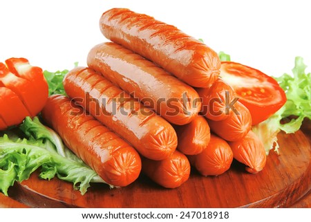 served grilled beef red sausages on wooden plate