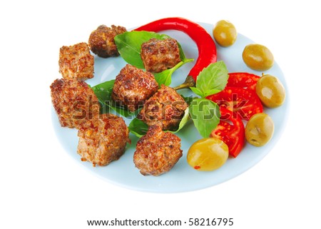 served meat cutlets with basil and tomatoes