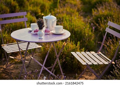 Served Table With Chairs For An Outdoor Tea Party In A Field With Lavender At Sunset