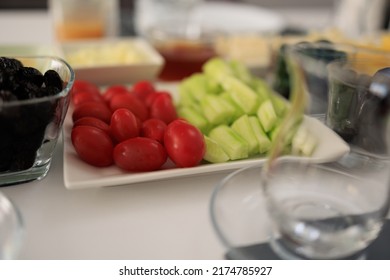 Served table with different dishes and snacks, fruits, vegetables and cheeses.