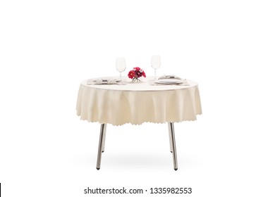 Served table with plates, napkins, wine glasses and flower decoration isolated on white background