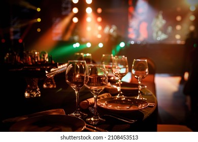 Served Table In A Restaurant At The Holiday. Empty Glasses Before The Party. Concert Light