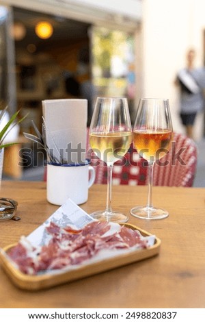Served table set at summer terrace cafe. Romantic table for two person. Two Glasses with wine on table in a restaurant, alcohol luxury background.