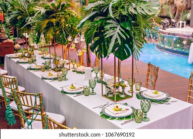 Served table at a tropical party decorated with orchids