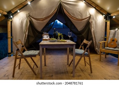 Served Table And Two Chairs Prepared For Romantic Dinner Inside Large Glamping Tent