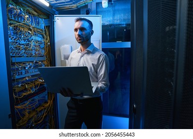 Server administrator doing network maintenance in data center