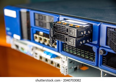 Server with blue case and opened hard drive bays.