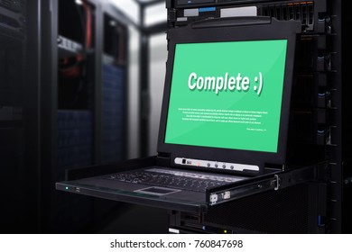 Server computer KVM display show "complete" messages on screen in the modern interior of data center. Super Computer, Server Room.