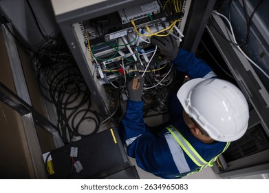 Server expert repair technicians are checking the integrity of server cabinet cable connections to ensure proper and efficient internet operation.