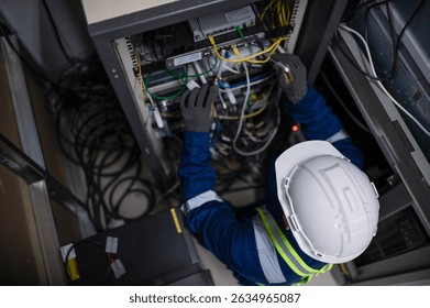 Server expert repair technicians are checking the integrity of server cabinet cable connections to ensure proper and efficient internet operation.