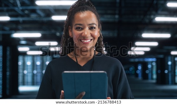 Server Farm Cloud. Computing Specialist\
Facility with Multiethnic Female System Administrator Working with\
Data Protection Network for Cyber Security. Data Center Engineer\
Using Tablet Computer.
