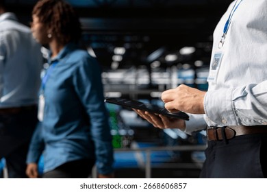 Server farm data scientist using tablet to review AI LLM visualization, intelligent systems for operational stability. Engineer analyzes neural network outputs for stable operations.