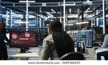 Server farm engineering team collaborating to protect against data theft during cyberattack. Data center coworkers rushing to safeguard infrastructure systems during security breach, camera A