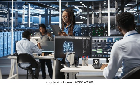 Server farm engineering team using AI algorithms and node tree systems to categorize unstructured data. Data center IT experts use visual programming and natural language processing software, camera A