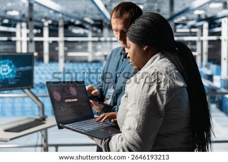 Server hub colleagues using AI to detect abnormal network traffic patterns caused by hacker attack. Data center specialists deploying artificial intelligence countermeasures to neutralize hacking