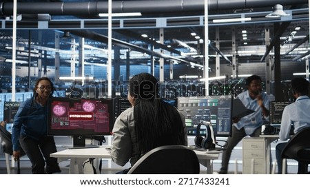 Server hub coworkers react to security breach after unauthorized access bypassing firewall compromising data. Employees initiate emergency response protocols after cybersecurity alert, camera A