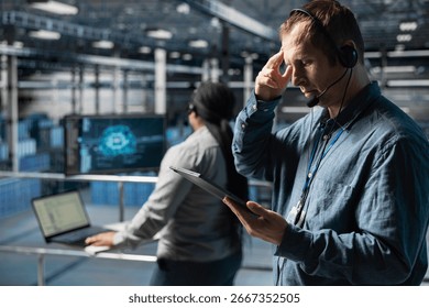 Server hub technicians identifying hardware issues using predictive machine learning alerts, guiding users. Teamworking data center coworkers using headset mic, using AI to resolve clients issues