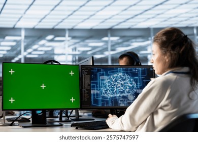 Server hub worker working on green screen computer, using AI to process data. IT programmer at chroma key PC updating servers controlling network resources using artificial intelligence
