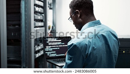 Server room, black man or coding with laptop for system upgrade, cybersecurity or screen. Software management, data or male programmer with digital for problem solving, analytics or troubleshooting