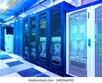 Server room with control modules in racks datacenter under blue toning