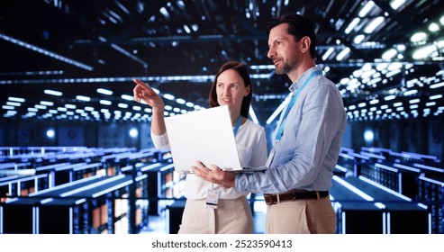 Server Room In Data Center. Cloud Computer Engineers Configuring AI Technology - Powered by Shutterstock