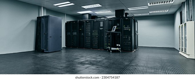 Server room, empty or data center for internet connection, computing network or cyber security hardware. IT support background, information technology or machine equipment with laptop in a datacenter