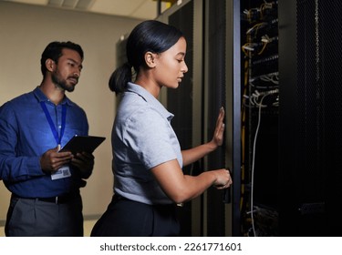Server room, engineer teamwork and woman opening panel for maintenance or repairs at night. Cybersecurity, programmers and female with man holding tablet for software or networking in data center.