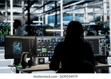 Server room engineer using artificial intelligence to enhance operational efficiency and reduce downtime. Admin AI driven solutions for data center infrastructure using node trees on PC