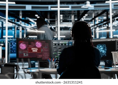 Server room expert receiving critical error popup on PC while using artificial intelligence to reduce downtime. Admin dealing with bugs, getting warning message while implementing AI in data center