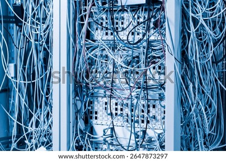 server room rack with tangled network cables creating messy untidy network system