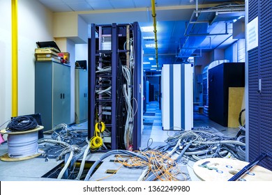 Server room with racks in datacenter and internet problem causing by disorder of wiring. - Powered by Shutterstock