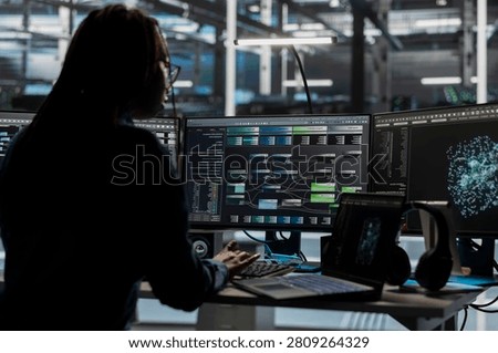 Server room software developer reviews AI visual analytics dashboard to pinpoint equipment performance problems.