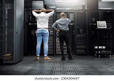 Server room, it support or electrician fixing a problem for hardware maintenance or stressful glitch crisis. Confused or back of worried technicians or electrical engineers in information technology - Powered by Shutterstock