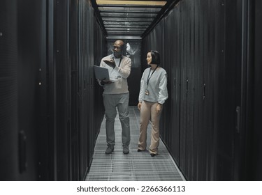 Server room, teamwork or people on laptop for software management, system upgrade or cyber security. Network technician, engineer or programmer staff on tech for information technology or programming
