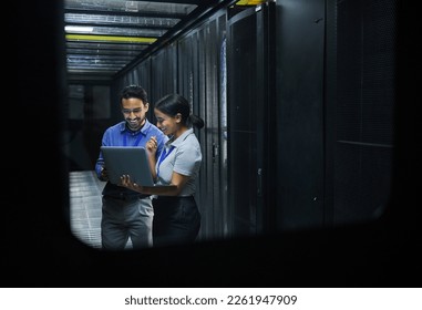 Server room, technician people and laptop for software management, system upgrade or cyber security. Teamwork, data center and engineer or programmer employees, information technology and programming