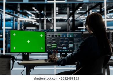 Server room technician using artificial intelligence tech on green screen PC to reduce downtime. Admin using chroma key computer to design and implement AI driven solutions for data center equipment