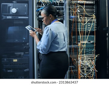 Server room, woman and engineer with tablet for cybersecurity, programming or cable maintenance. Black female technician in datacenter for network, software or system upgrade with IT app and internet - Powered by Shutterstock