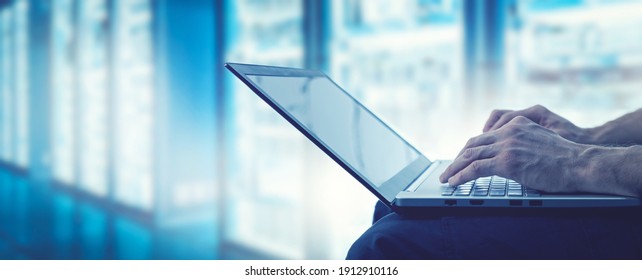 server support and management - it technician working on laptop in data center server room. copy space - Shutterstock ID 1912910116